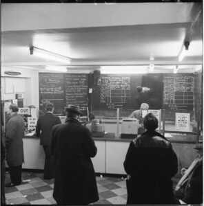 Inside a bookmaker’s in Monument, London, 1966. A new sight after the Betting & Gaming Act of 1960. Photographer: Henry Grant. Credit: London Museum. Creative Commons License CC BY-NC 4.0.