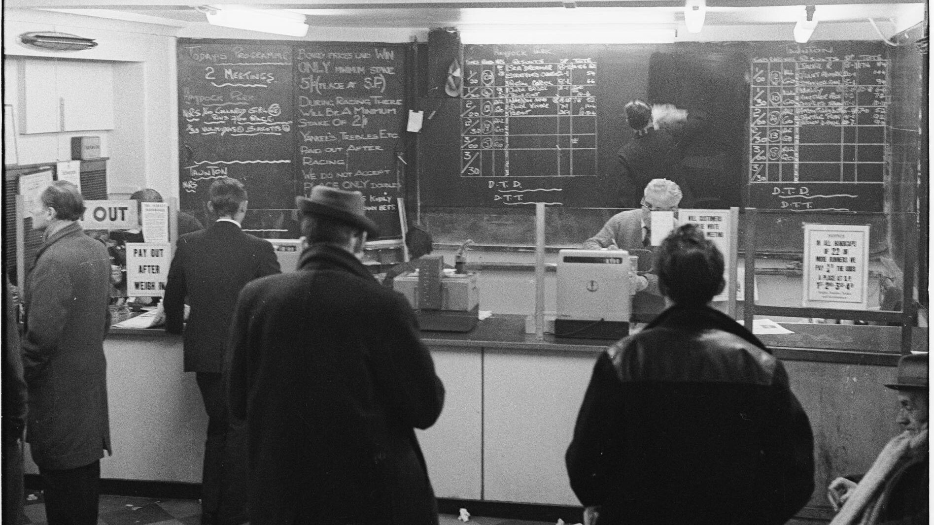 Inside a bookmakers in Monument, London, 1966. A new sight after the Betting & Gaming Act of 1960. Photographer: Henry Grant. Credit: London Museum. Creative Commons License CC BY-NC 4.0.